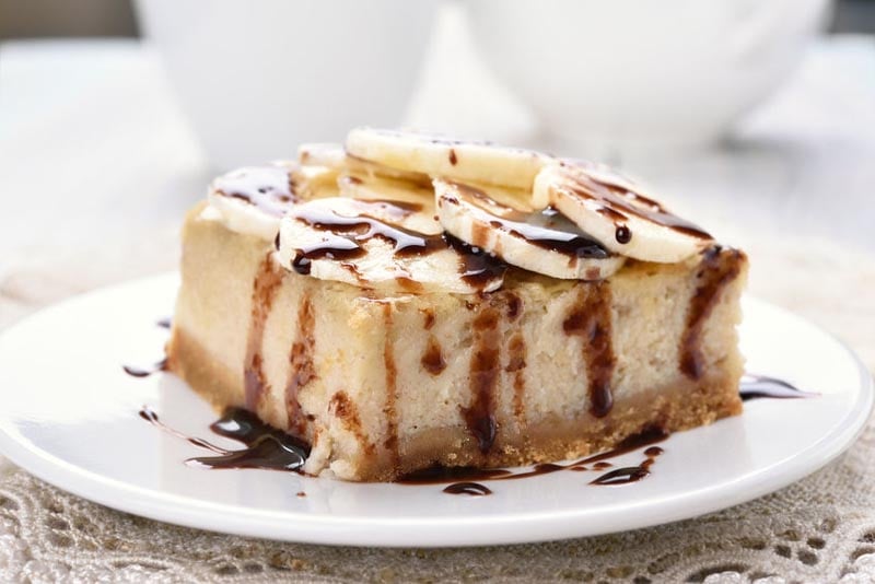 Gluten Free Banana Cheesecake Bars Topped with Chocolate Syrup