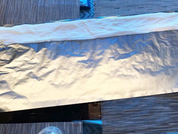 Wet Paper Towel Strip at the Top of a Sheet Aluminum Foil