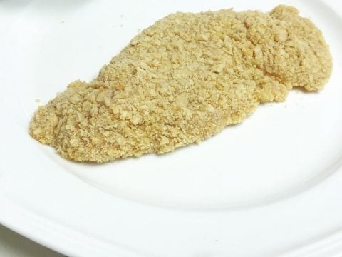 Breaded Raw Chicken Using Toasted Corn Tortilla Crumbs on a Raw Chicken Breast