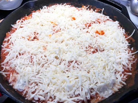 Shredded Mozzarella Cheese on top of Lasagna